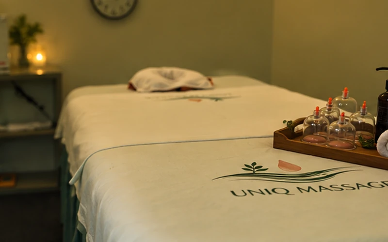 Therapist performing cupping therapy at Uniq Massage