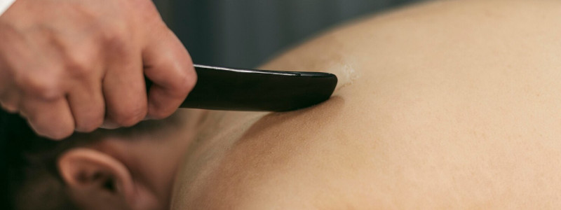 Gua sha massage add-on at Uniq Massage in McKinney TX for fascial release and improved circulation