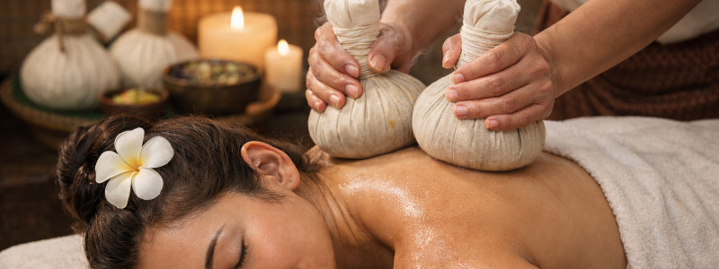 Herbal compress massage add-on at Uniq Massage in McKinney TX using heated herb-filled bundles to soothe muscles and improve circulation