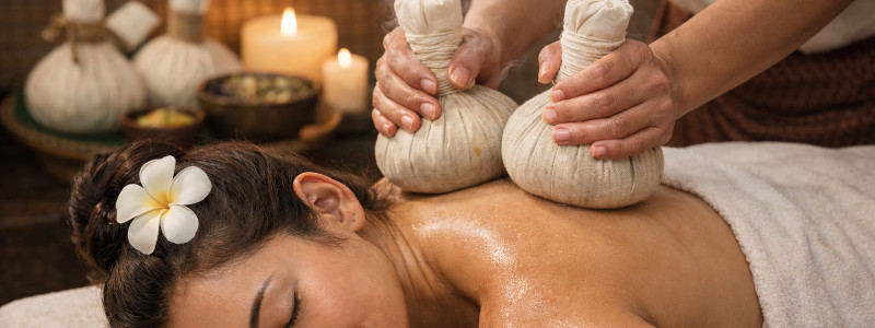 Herbal compress massage add-on at Uniq Massage in McKinney TX using heated herb-filled bundles to soothe muscles and improve circulation