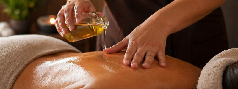 Herbal pain relief oil massage add-on at Uniq Massage in McKinney TX for targeted muscle and joint pain relief